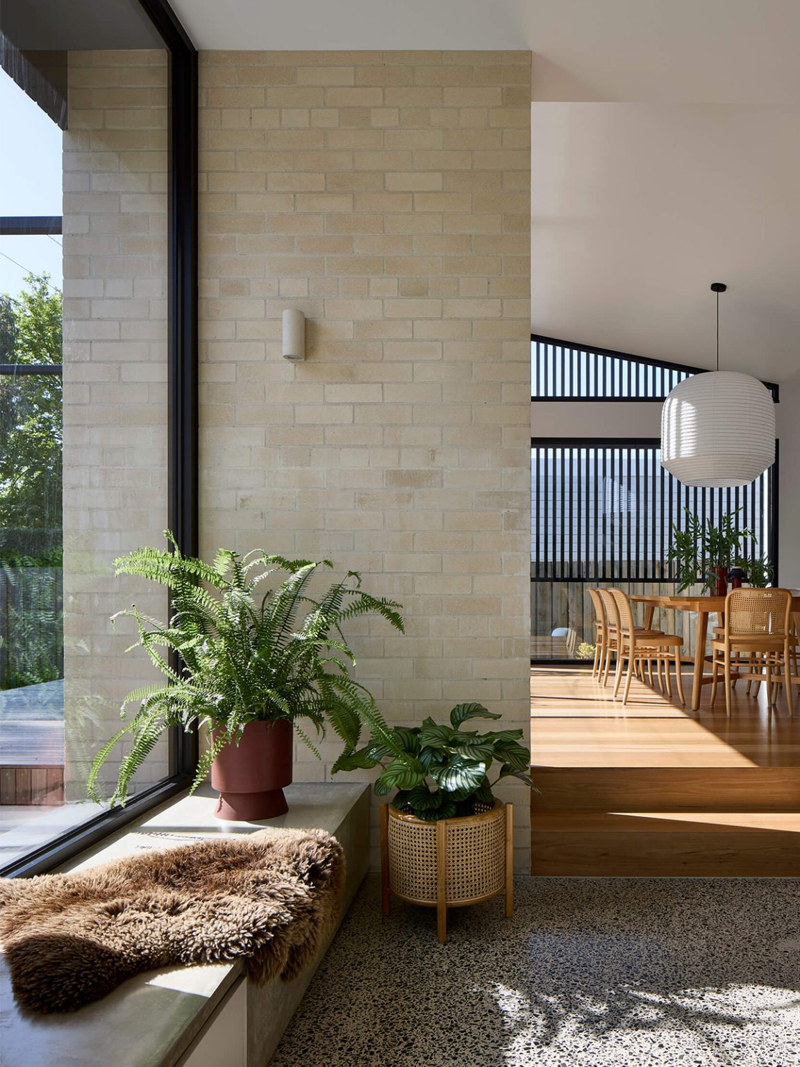 Sunken lounge with exposed brick walls and full height glazing